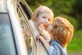 Good bye before car travel. Cute children saying goodbye before car travel.