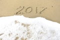 Good bye 2016 hello 2017. inscription written in the beach sand.