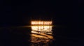 Good bye 2023 illuminated sign installation in water on the beach on black background. Old year is burning. Happy winter holidays Royalty Free Stock Photo