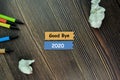 Good Bye 2020 write on sticky note and isolated on Wooden Table. New Year Concept