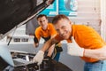 Good car service staff happy mechanic teamwork for engine check