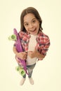 Good choice. Kid girl happy holds penny board. Child likes plastic skateboard shows thumb up. Modern teen hobby. Girl