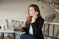 Good day I want to submit internet order. Portrait of good-looking busy woman sitting in cafe, making reservation in