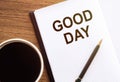 GOOD DAY - text on notepad on wooden desk Royalty Free Stock Photo