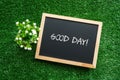 GOOD DAY text in white chalk handwriting on a blackboard Royalty Free Stock Photo