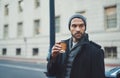 Good days start with coffee. a fashionable young man in an urban setting. Royalty Free Stock Photo