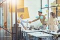 Good deal. Two businessmen or coworkers shaking hands while having a meeting with colleagues in the modern office Royalty Free Stock Photo