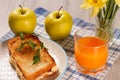Toast with butter and cheese on white plate, two apples, glass o Royalty Free Stock Photo