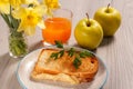 Toast with butter and cheese on white plate, two apples, glass o Royalty Free Stock Photo