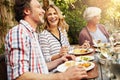 Good food, great life. a family eating lunch together outdoors.