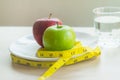 Good food for good health. Breakfast meal apple and water on the table.