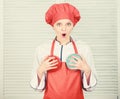 Good food for good health. cook in restaurant, uniform. girl in apron and hat hold bowls. professional chef cooking in