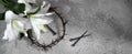 Good Friday, Passion of Jesus Christ. Crown of thorns, nails and white lily on grey background. Christian Easter holiday Royalty Free Stock Photo