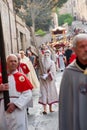 the Good Friday procession in Assisi with the penitent cross-bearer and members of the lay confraternities Royalty Free Stock Photo