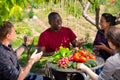 Good friends have conversation at table in backyard of village house