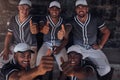 Good game. a group of young baseball players sitting in the dugout and showing thumbs up. Royalty Free Stock Photo