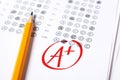 Good grade of A plus is written with red pen on the tests.