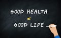 Good Greatly Equal Good Life Conceit On Chalkboard With Human hand Writing text in blackboard . Conceptual Idea of health Royalty Free Stock Photo