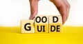 Good guide symbol. Concept words Good guide on wooden cubes. Businessman hand. Beautiful yellow table white background. Good guide Royalty Free Stock Photo