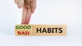 Good habits symbol. Businessman turns a wooden block and changes words `bad habits` to `good habits`. Beautiful white backgrou Royalty Free Stock Photo