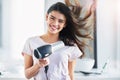 Good hair day, here I come. Portrait of a beautiful young woman blowdrying her hair in the bathroom at home.