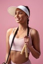 Good health inspires happiness. an attractive and sporty young woman posing with a skipping rope in studio against a Royalty Free Stock Photo