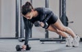 Good health looks gorgeous on you. a young woman working out with weights in a gym. Royalty Free Stock Photo