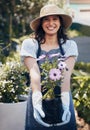 Good health and a sense of well being. a young female florist working at a nursery.