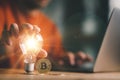 Good idea for cryptocurrency concept- digital market. man touching on lightbulb with Golden Bitcoins, Business and Finance, Saving