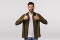 Good idea, supportive friend encourage take action, like idea. Attractive bearded man in coat, show thumbs-up and