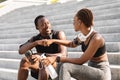 Good Job Partner. Black Athlete Guy And Girl Fist-Bumping After Training Outdoors