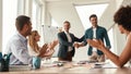 Good job Two cheerful colleagues shaking hands and smiling while having a meeting in the modern office Royalty Free Stock Photo