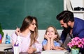 Good learning environment. Learners must feel supported welcomed and respected. Mom and dad teachers helping child with Royalty Free Stock Photo