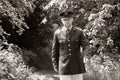 Handsome American WWII GI Army officer in uniform walking through woods