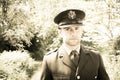 Handsome American WWII GI Army officer in uniform walking through woods
