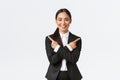 Good-looking asian saleswoman suggest two choices. Attractive businesswoman in black suit pointing fingers sideways