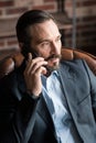 Good looking bearded businessman communicating via cell phone Royalty Free Stock Photo