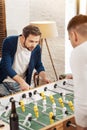 Good looking bearded man playing the table soccer Royalty Free Stock Photo