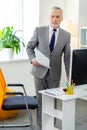 Good-looking bearded office worker being busy at work