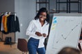 Good-looking black business lady explain business strategy to young leaders Royalty Free Stock Photo