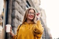 Good-looking blond girl with long hair while walking down the street Outdoor portrait of fair-haired young woman in bright sweatsh Royalty Free Stock Photo