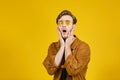 guy with yellow sunglasses posing on a yellow background