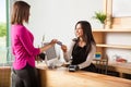 Good looking brunette paying with credit card Royalty Free Stock Photo