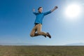 Casual man jumping with hands in the air carefree Royalty Free Stock Photo