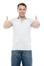 Good looking cheerful man showing double thumbs up