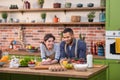 Good looking couple very charismatic multiracial have a romantic time at the kitchen taking video closeup they hugging Royalty Free Stock Photo