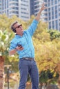 Good looking elderly man listening music on the street Royalty Free Stock Photo