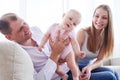 Good-looking father holding fantastic baby while sitting with wi Royalty Free Stock Photo