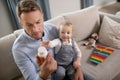 Good-looking father looking attentive reading about vitamins