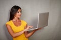 Good-looking female using laptop while standing Royalty Free Stock Photo
